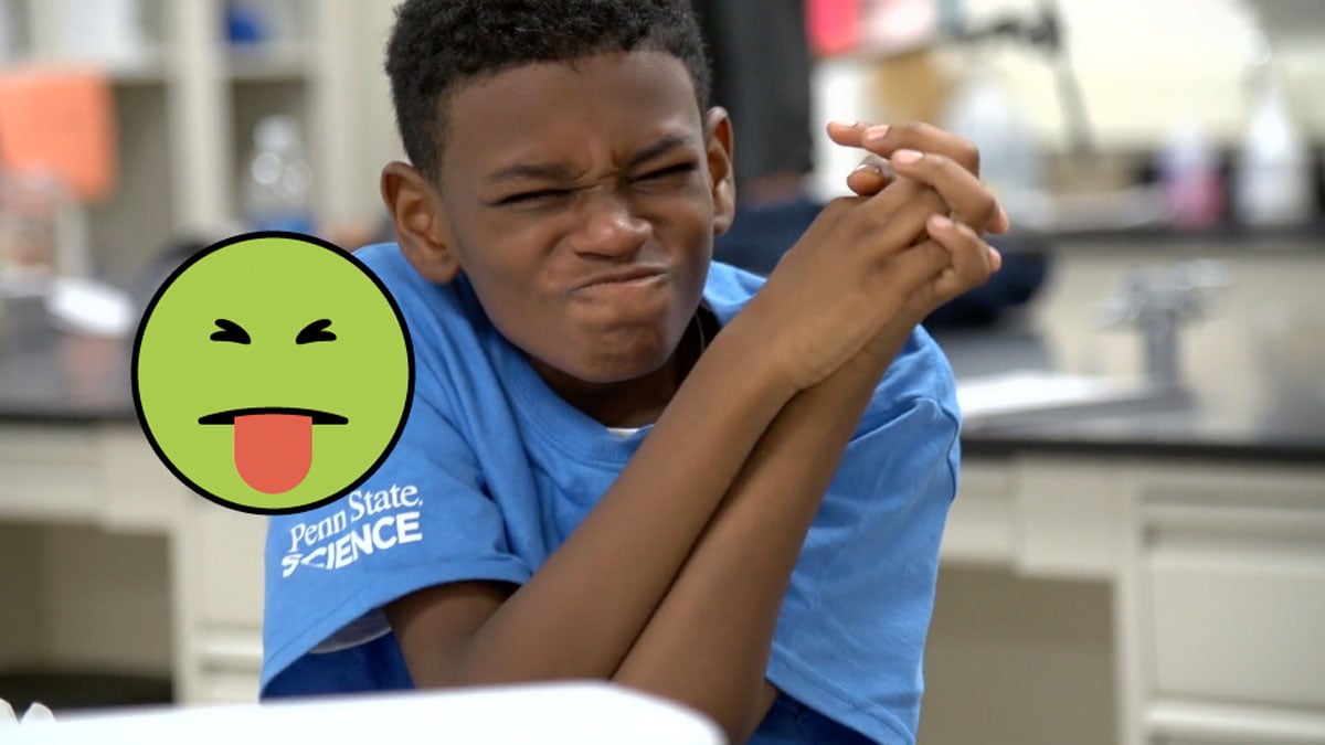 A kid scrunches his face in discomfort after tasting a very bitter substance